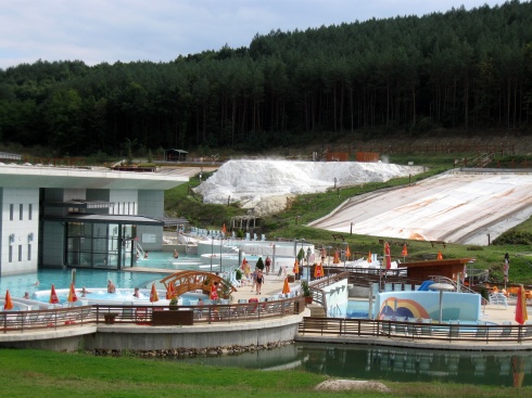 The outdoor pools at the hot springs spa.  The white pile on the hill is salt that has been removed from the water.