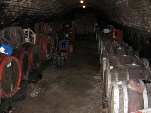 The actual cellar at the wine cellar with casks of wine.